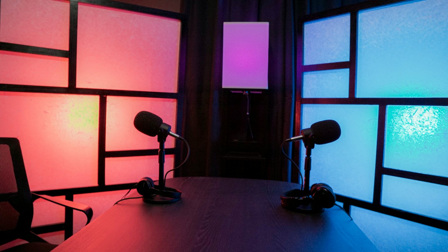 Podcasting equipment on a table in a studio.